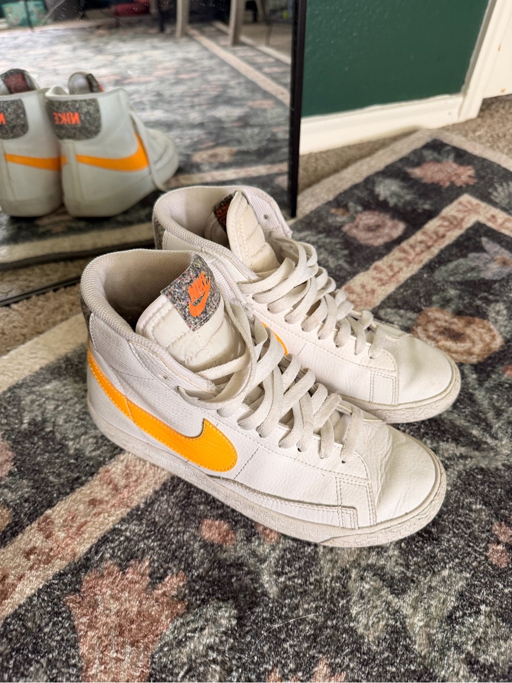 Nike White High-Top Sneakers with Orange Swoosh